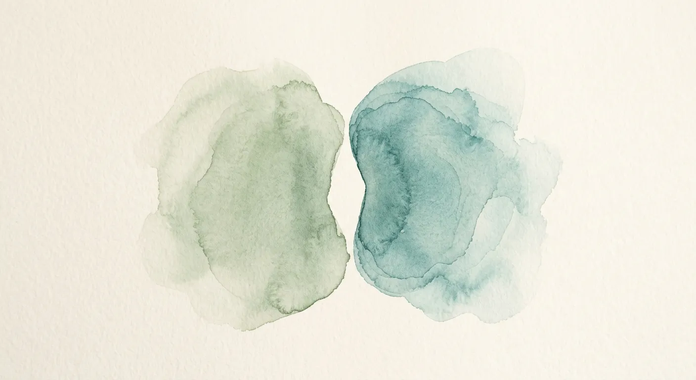 Two soft watercolor circles overlapping in muted blues and greens